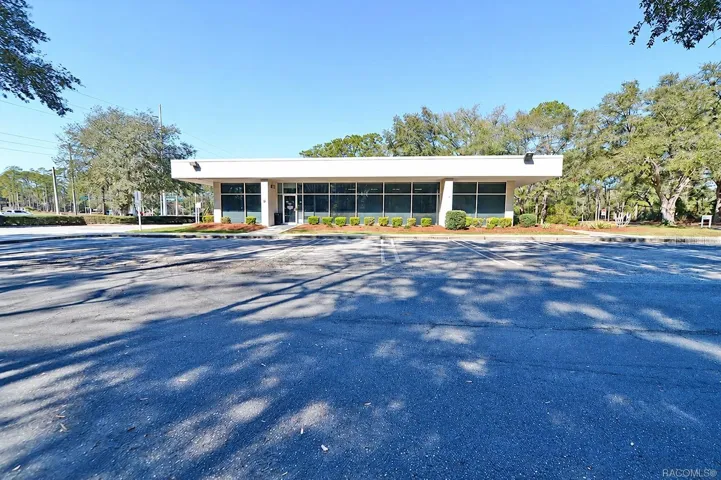 Front elevation with a broad window line and customer entrance. Digitally edited to remove former bank signage.