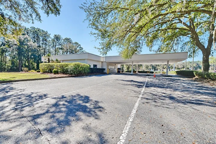 Rear view of the covered drive-through lanes. Digitally edited to remove former bank signage.