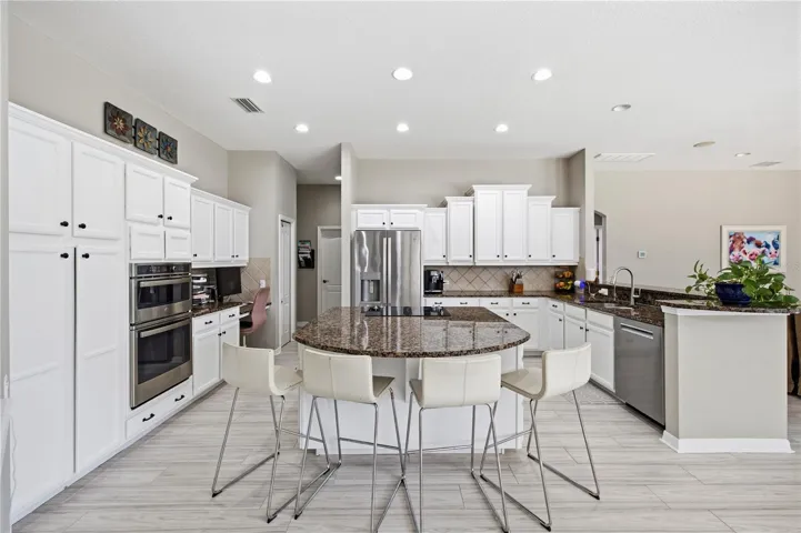 Huge kitchen with customized storage solutions in cabinets.