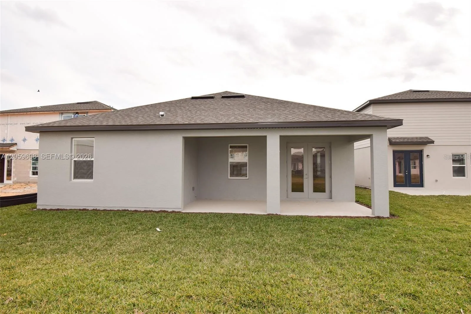 Rear Exterior with Covered Patio and Backyard
