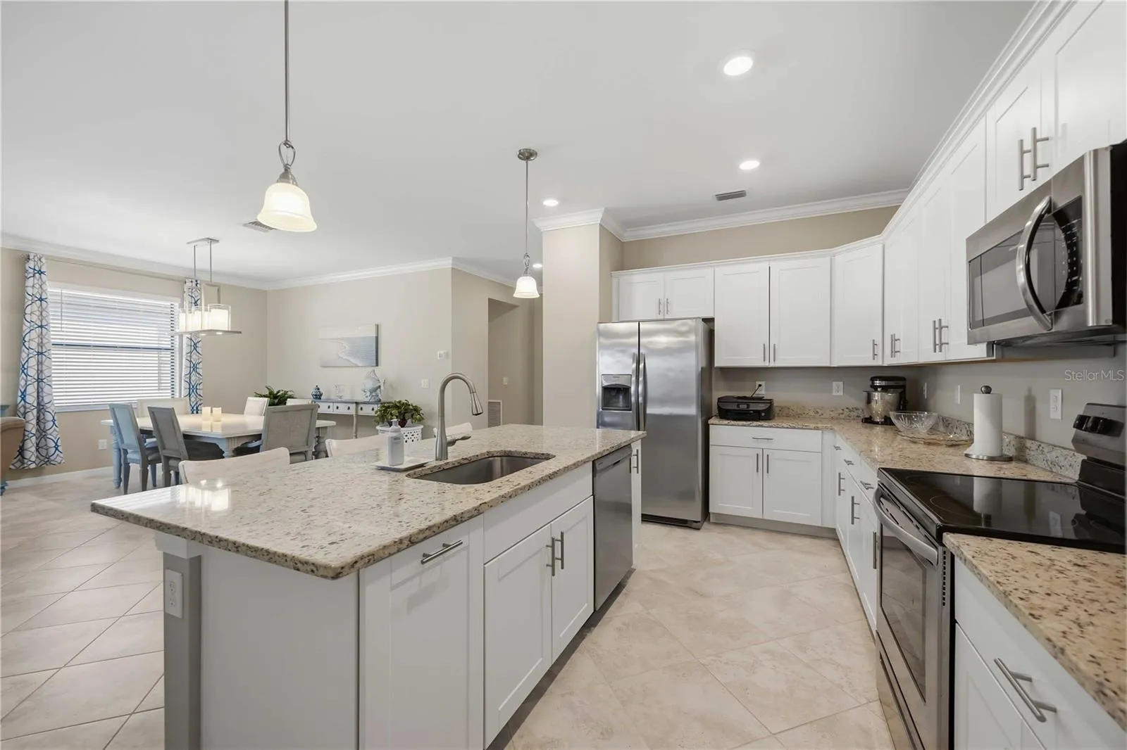 Granite counters, stainless steel appliances and white shaker cabinetry