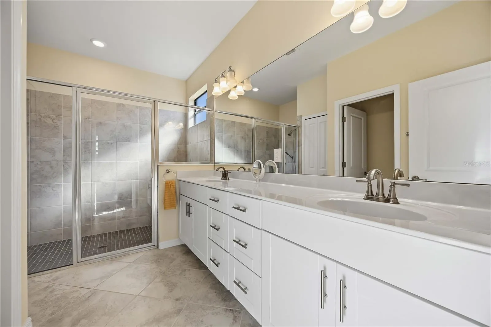 Owner's Bath with spacious tile shower and dual vanities