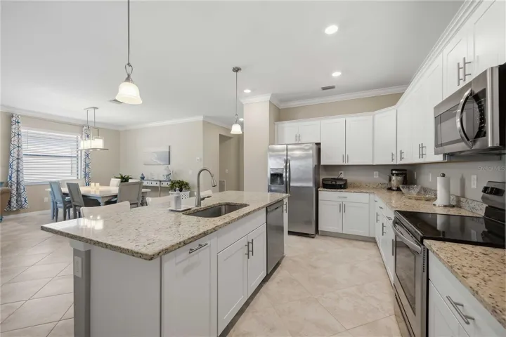 Granite counters, stainless steel appliances and white shaker cabinetry