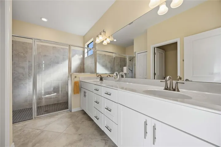 Owner's Bath with spacious tile shower and dual vanities