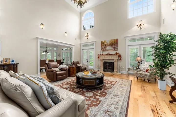 Family room with 22' ceiling and large windows to bring in natural sunlight