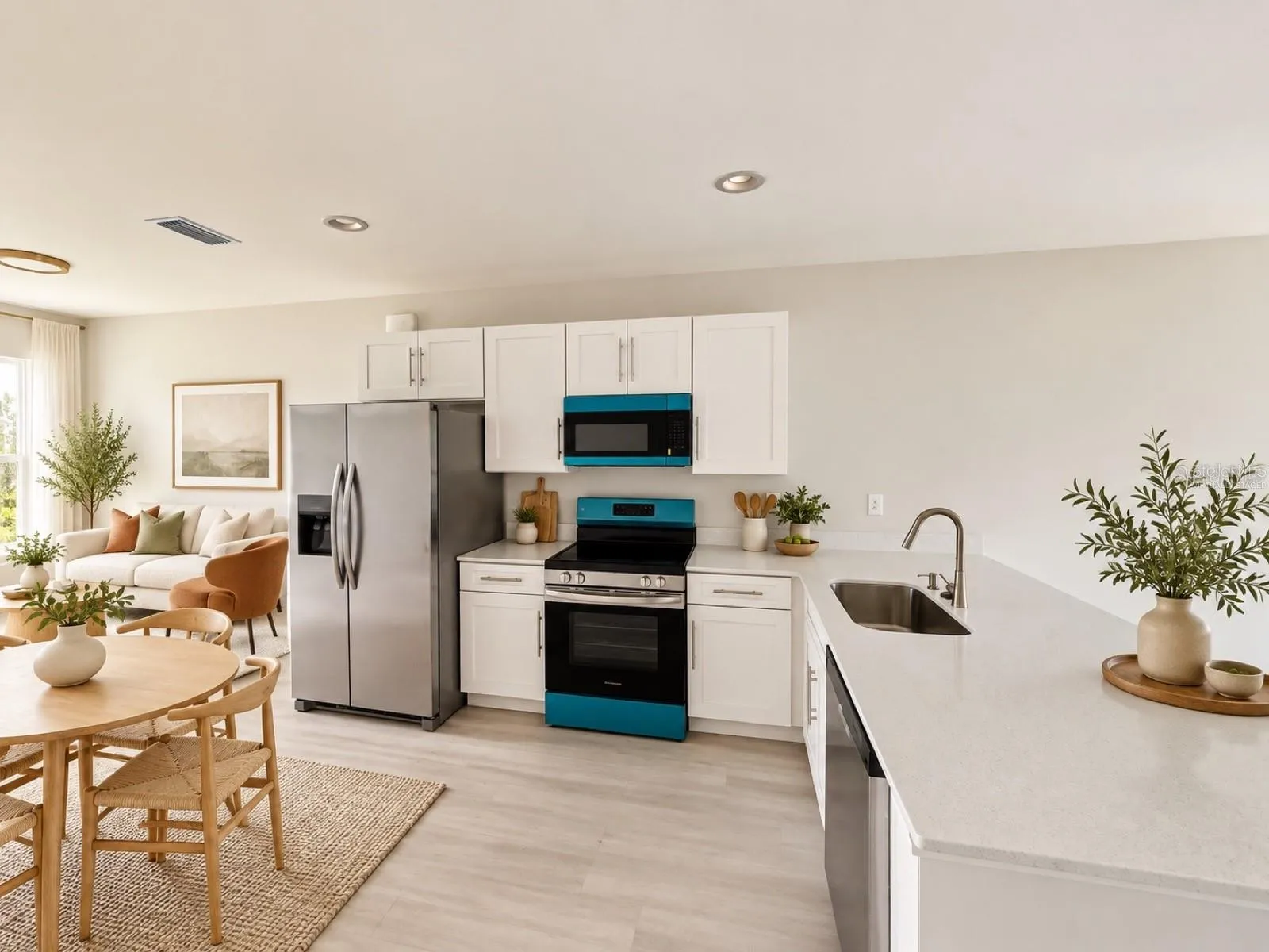 Virtually staged kitchen and dining area; furniture and decor are digitally added.