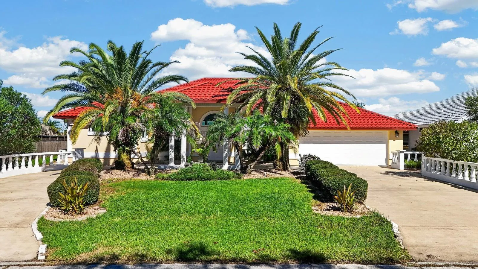 Palm-Lined Home With Circular Driveway