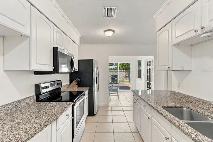 Galley-Style Kitchen Featuring Granite Countertops