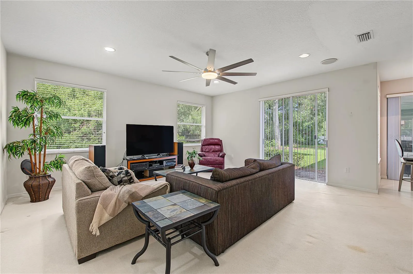 Oversized Family Room, with new ceiling fan and sliding doors to the back yard.