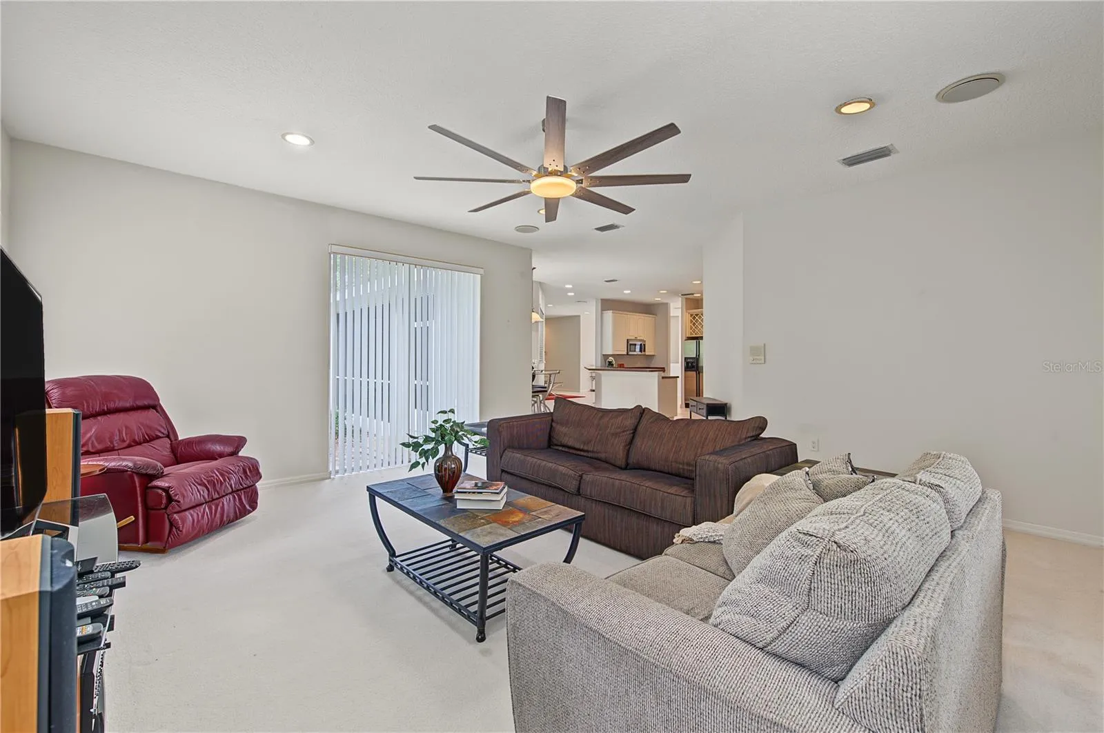 Oversized Family Room, with new ceiling fan and sliding doors to the back yard.