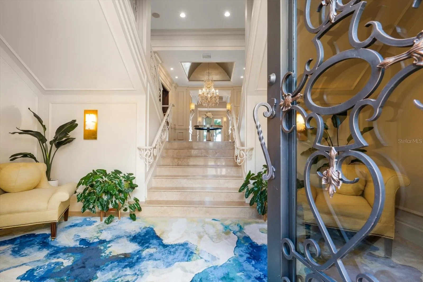 Limestone Tiled Entry and Custom Double Iron Front Doors