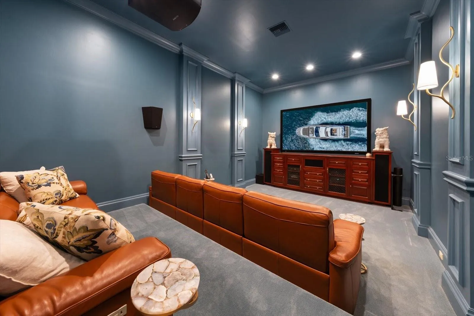 Media Room with a built-in projection screen and sound-blocking insulation with stadium style seating