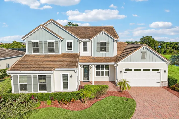BUILT IN 2021, this beautifully upgraded 5-bedroom, 3.5-bath home sits on an OVERSIZED .37 ACRE CUL-DE-SAC LOT overlooking LAKE HUCKLEBERRY in the Highlands at Summerlake Groves community!