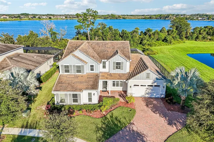 BUILT IN 2021, this beautifully upgraded 5-bedroom, 3.5-bath home sits on an OVERSIZED .37 ACRE CUL-DE-SAC LOT overlooking LAKE HUCKLEBERRY in the Highlands at Summerlake Groves community!