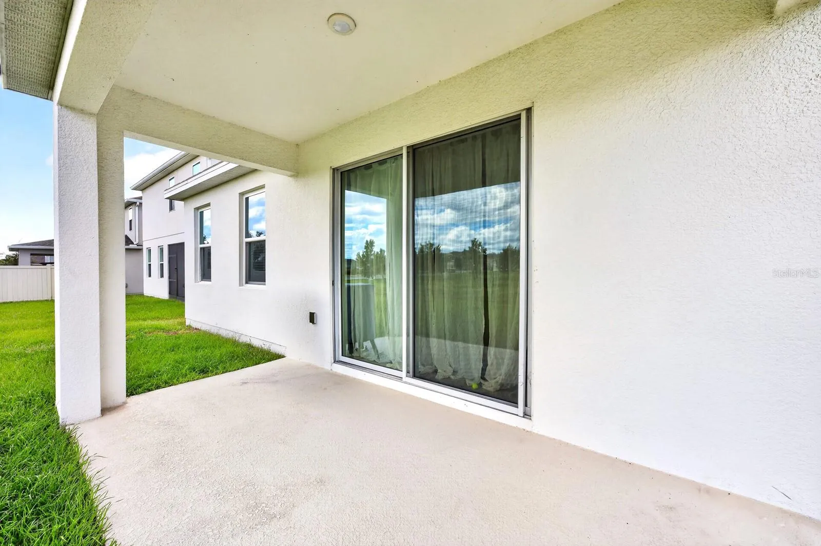 Step outside to the COVERED REAR PORCH overlooking the GENEROUS BACKYARD.