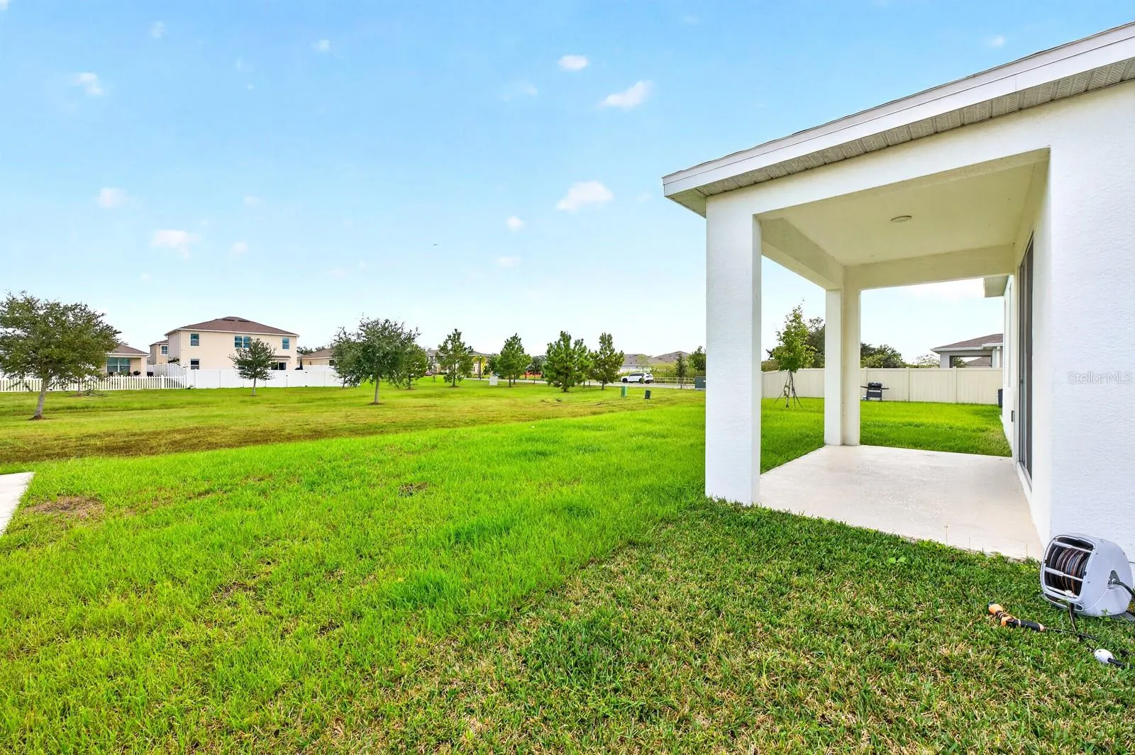 Step outside to the COVERED REAR PORCH overlooking the GENEROUS BACKYARD.