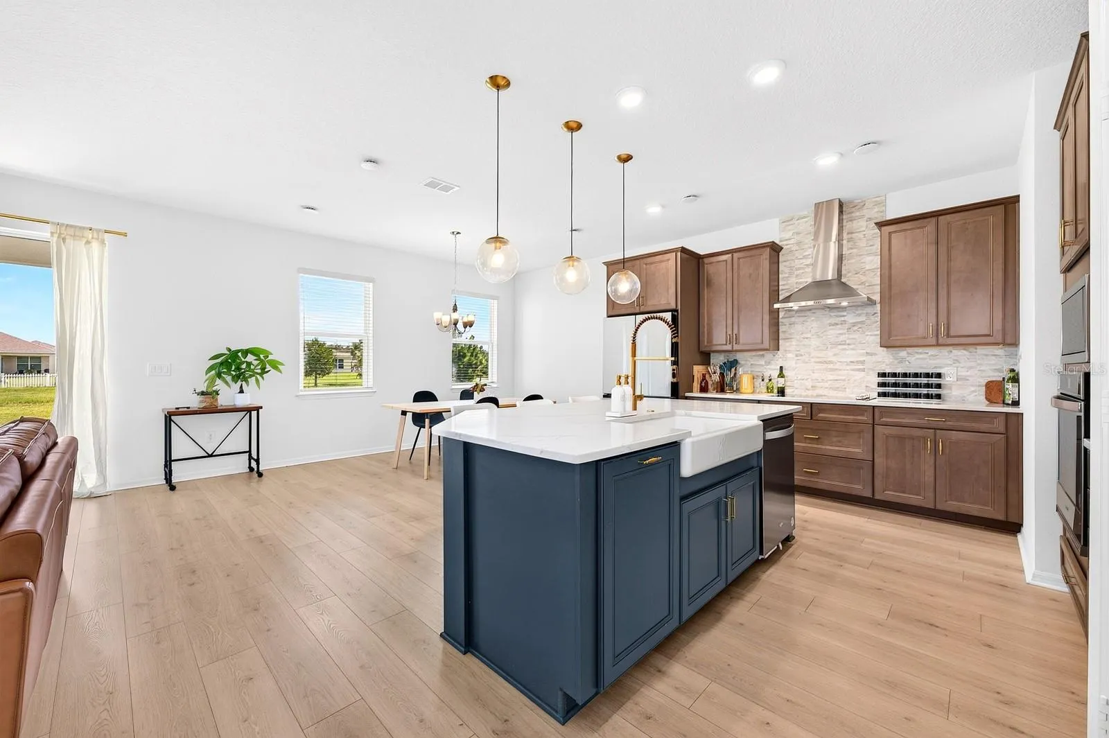 The Kitchen features a stylish Belfast sink that adds a touch of timeless character, beautifully complementing the quartz countertops, modern backsplash and sleek contemporary finishes.