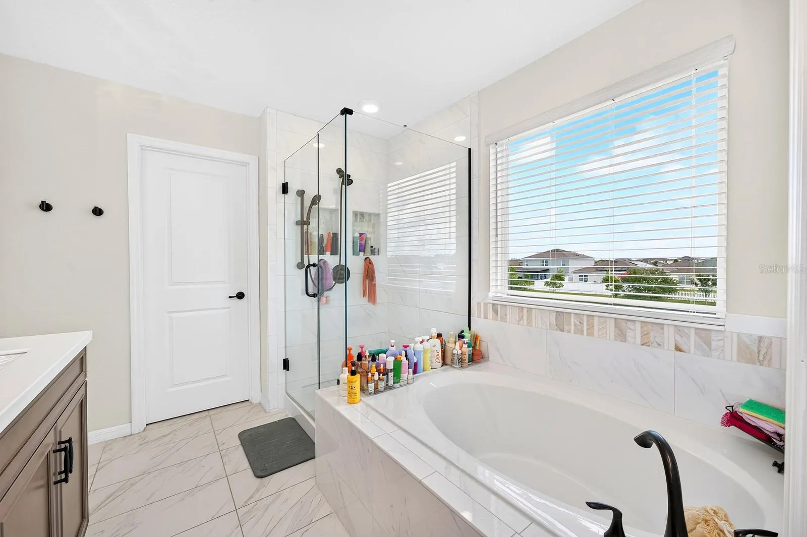 The Primary garden tub, step-in shower and private water closet.