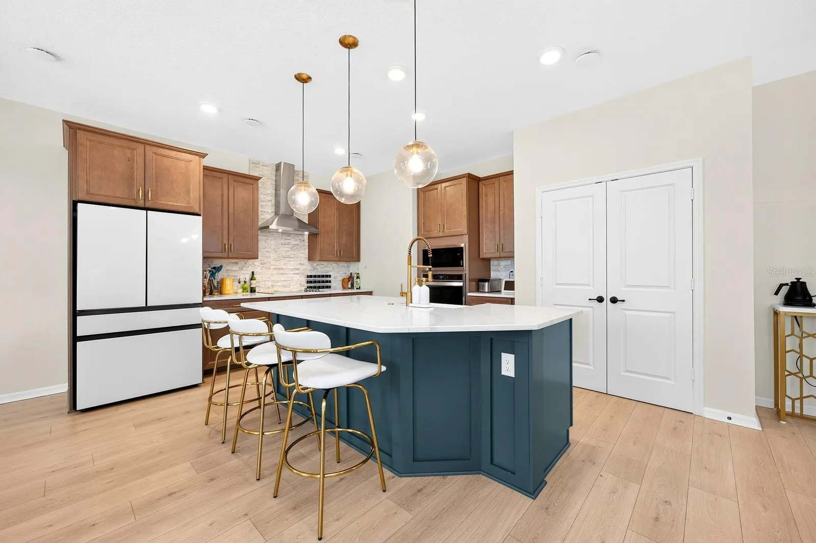 The Kitchen island includes space for counter-height seating.