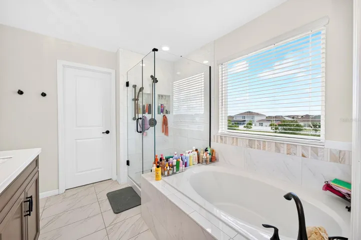 The Primary garden tub, step-in shower and private water closet.