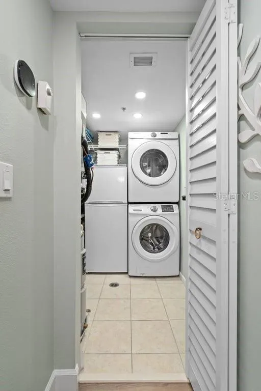 Laundry room with extra refrigerator.
