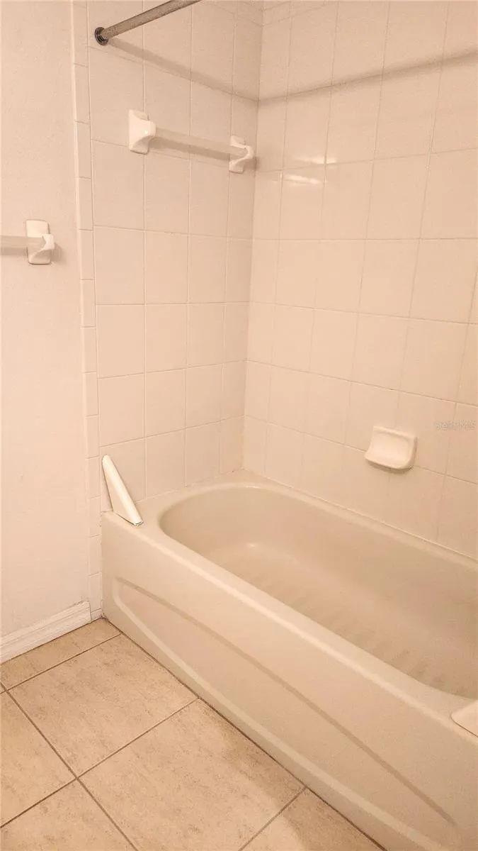Guest bathroom has a tub/shower combo.