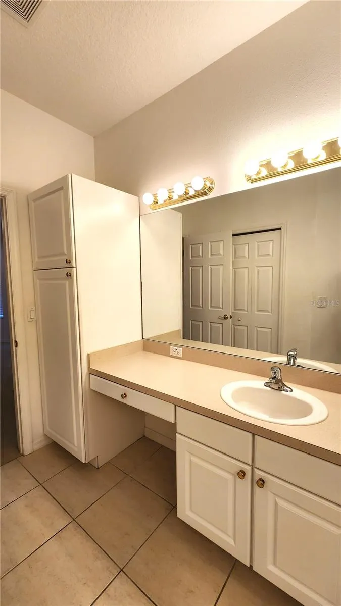 Primary Bathroom with Dual sinks and closet toilet.