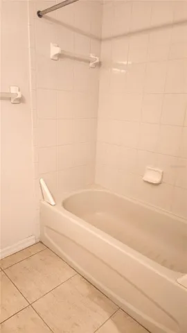 Guest bathroom has a tub/shower combo.
