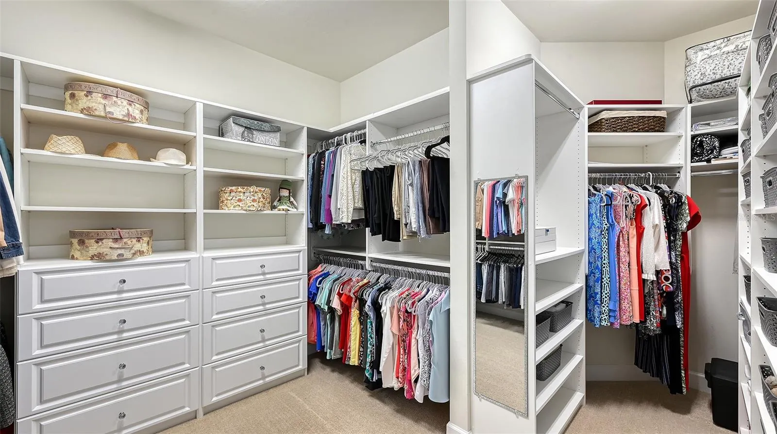 Primary closet with custom built-ins with an abundant amount of space for true luxury living.