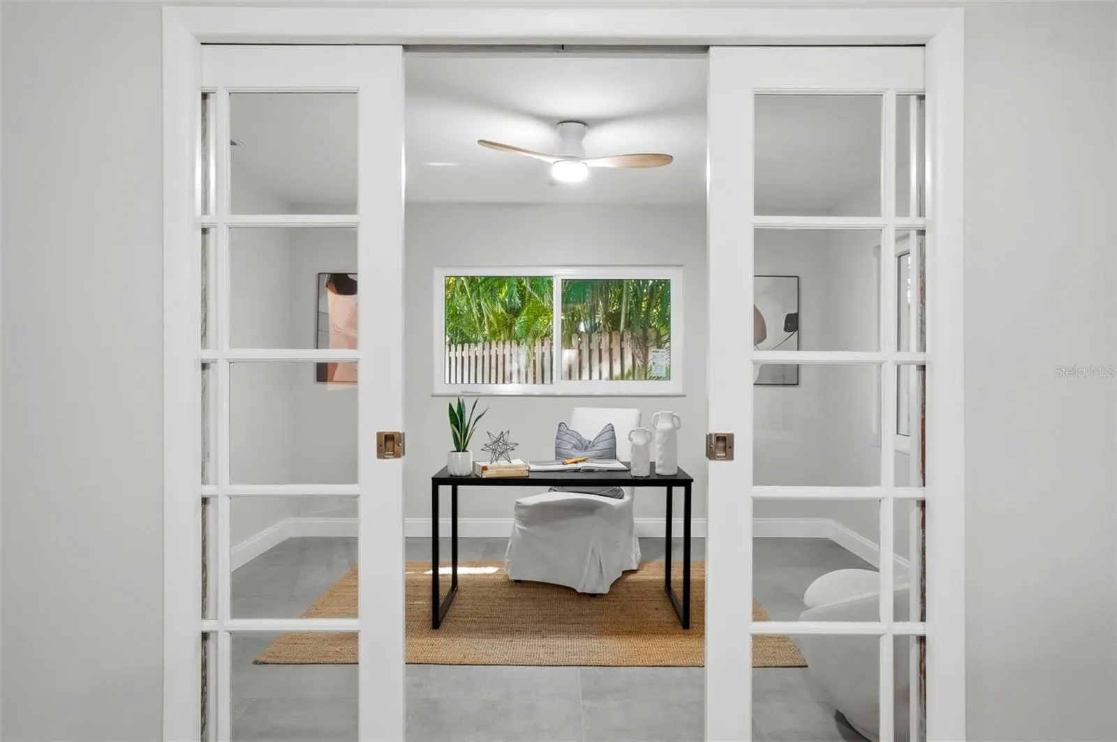 French pocket doors open to an additional room creating an ideal spot for a home office, studio, yoga room, or quiet retreat.