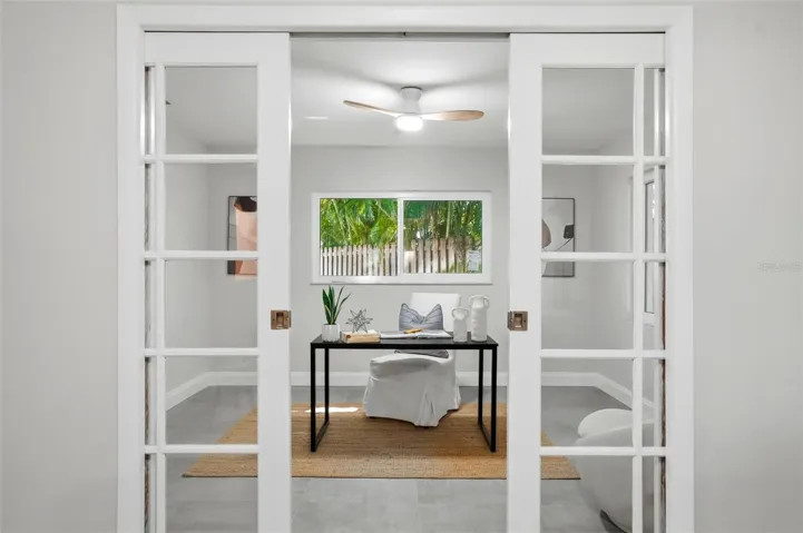 French pocket doors open to an additional room creating an ideal spot for a home office, studio, yoga room, or quiet retreat.