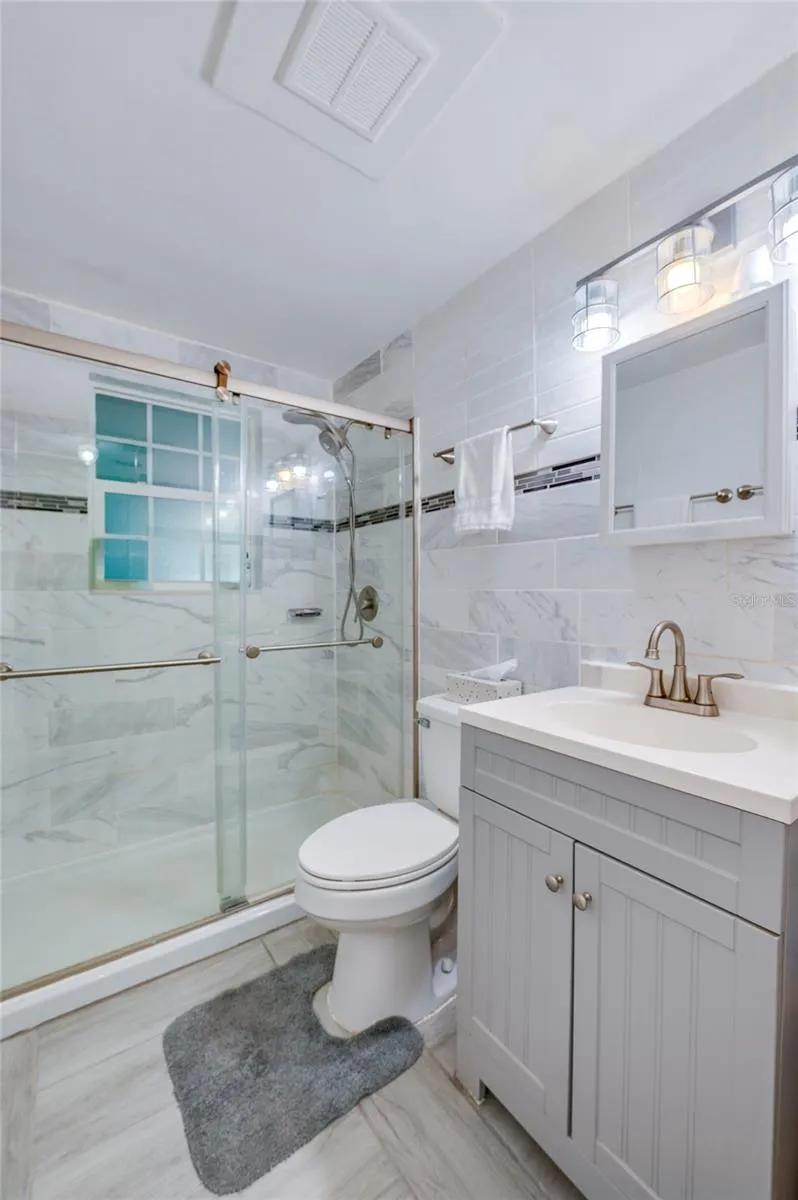 Remodeled bathroom with floor to ceiling tile
