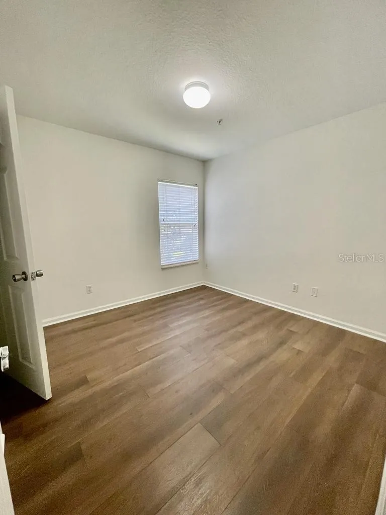 third bedroom with wood-look flooring