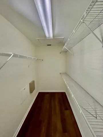 Generous walk-in closet with built-in shelving.