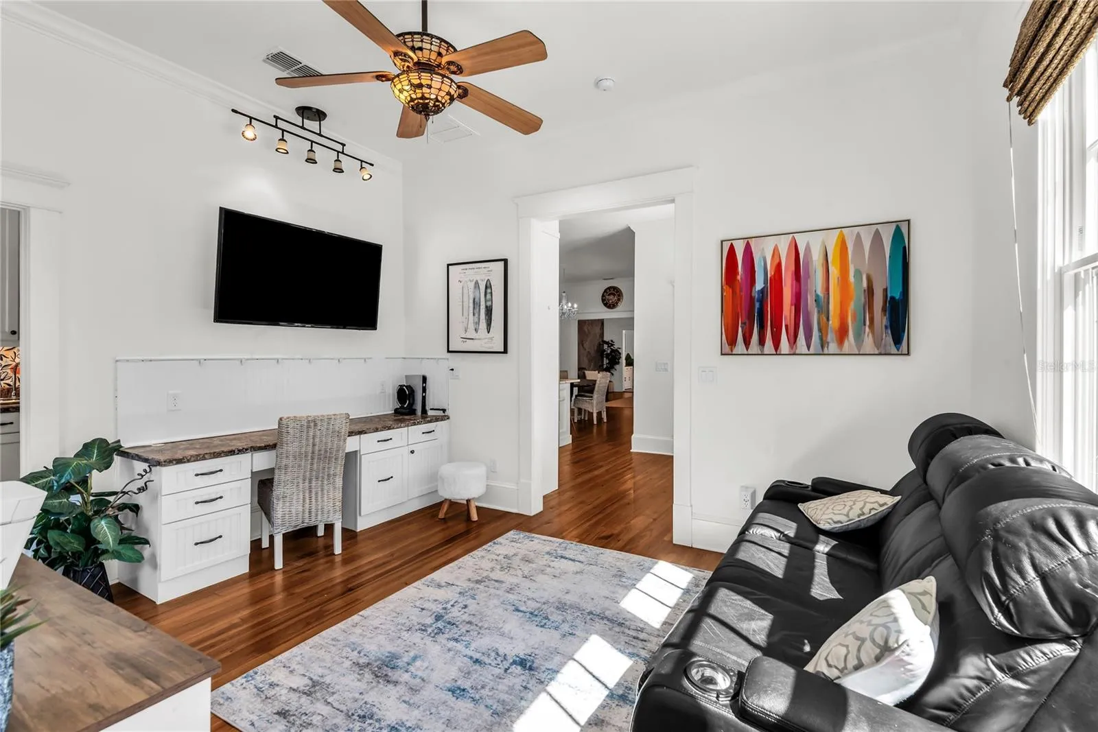 Home Office with custom built in desk and access to laundry room.