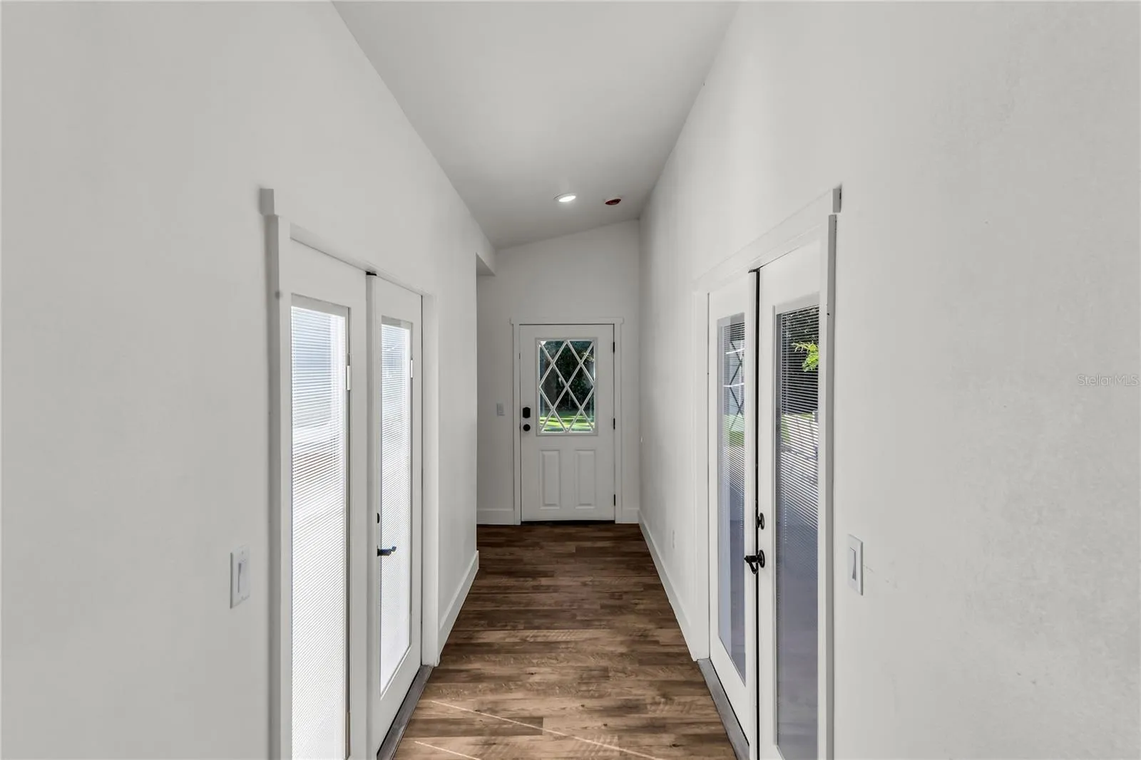 Private hallway leads to newly designed Primary Suite. French Doors lead to pool and backyard on one side and private courtyard on opposite side.