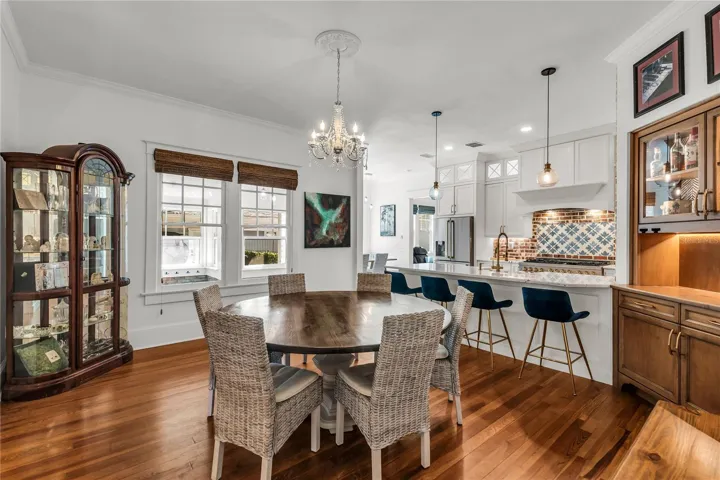 The Formal Dining room offers a seamless connection to the kitchen while maintaining its own distinct character. A custom built-in beverage bar serves as both a stunning focal point and dedicated space for serving coffee or refreshments.