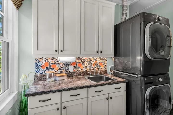 Laundry Room with sink, counterspace and cabinets for everday convenience