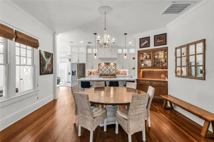 The Formal Dining room offers a seamless connection to the kitchen while maintaining its own distinct character. A custom built-in beverage bar serves as both a stunning focal point and dedicated space for serving coffee or refreshments.