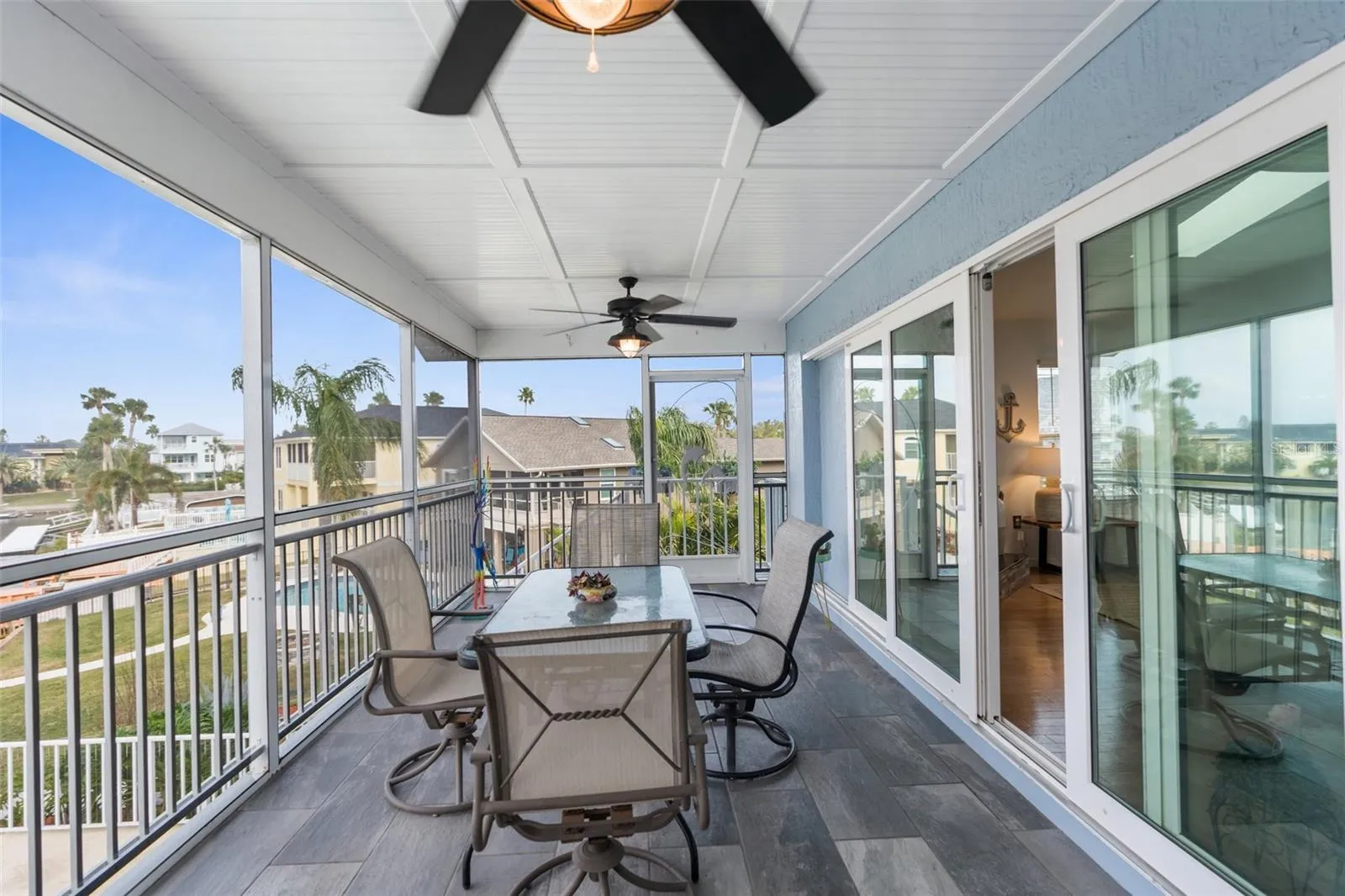 Back exposure deck off living room (screened). Located on second story.