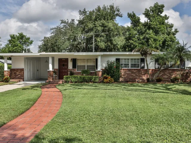 Front of the home with a brick sidewalk.