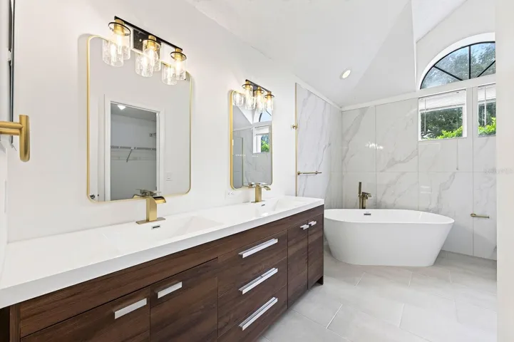 The Primary en suite Bath has been COMPLETELY UPDATED IN 2026 with dual sinks, a garden tub, a step-in shower and stylish MARBLE-LOOK tile walls.