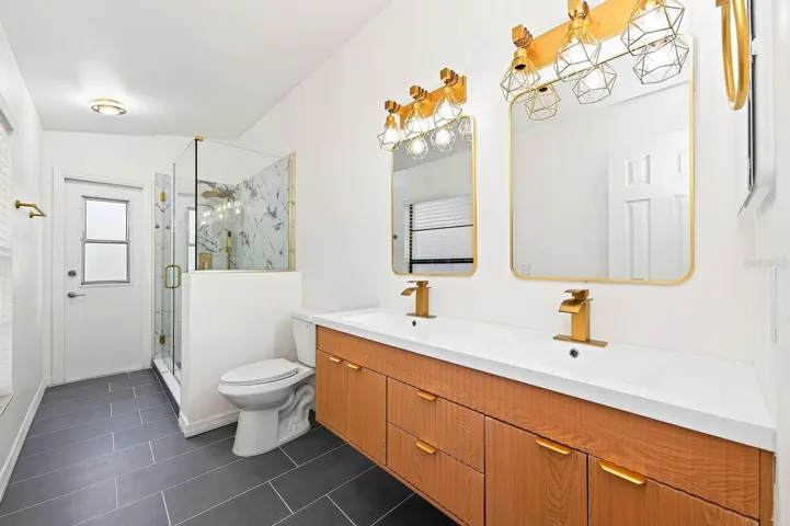 The second full Bath, also COMPLETELY UPDATED IN 2026, features dual sinks, a walk-in shower and a convenient door leading directly to the pool area.