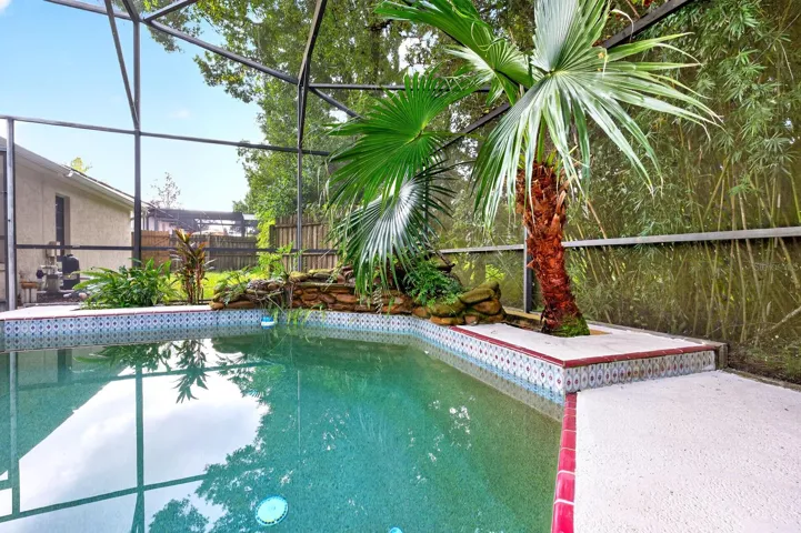 The in-ground pool and screened lanai create the perfect setting for swimming, relaxing and entertaining year-round.