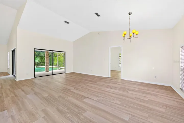 In the Living Room, sliding glass doors open to the PATIO AND POOL AREA—perfect for entertaining or enjoying a relaxed evening at home.