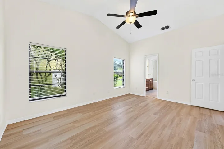 The spacious Primary Suite is filled with NATURAL LIGHT and features sliding glass doors that open directly to the pool and patio.