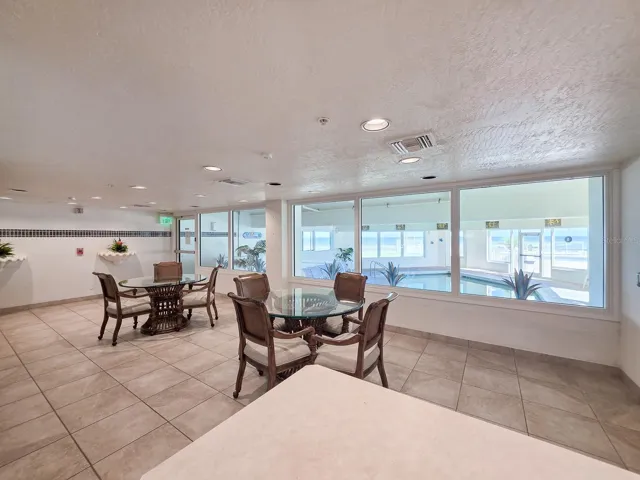 Community room with kitchen and view of the indoor heated pool