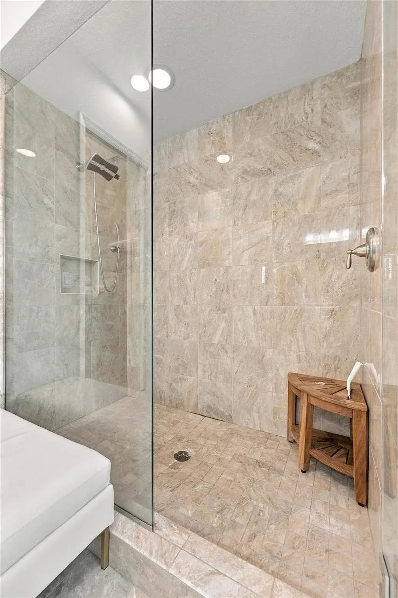 The spacious primary ensuite features dual vanities, a large walk-in shower, a private water closet, and convenient access to one of the suite’s two walk-in closets.