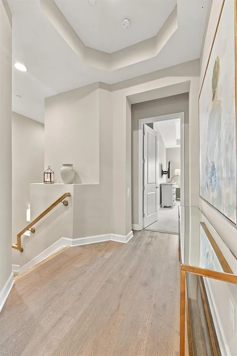 Hallway up the stairs that leads to the Primary Bedroom, 2nd Bedroom and Elevator.
