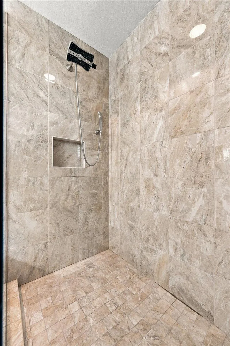 The spacious primary ensuite features dual vanities, a large walk-in shower, a private water closet, and convenient access to one of the suite’s two walk-in closets.